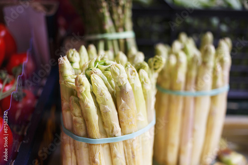 Peeled fresh asparagus at the street market/Natural organic green asparagus displayed at the market.