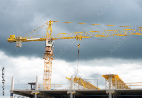 Working crane in the city. Construction site.