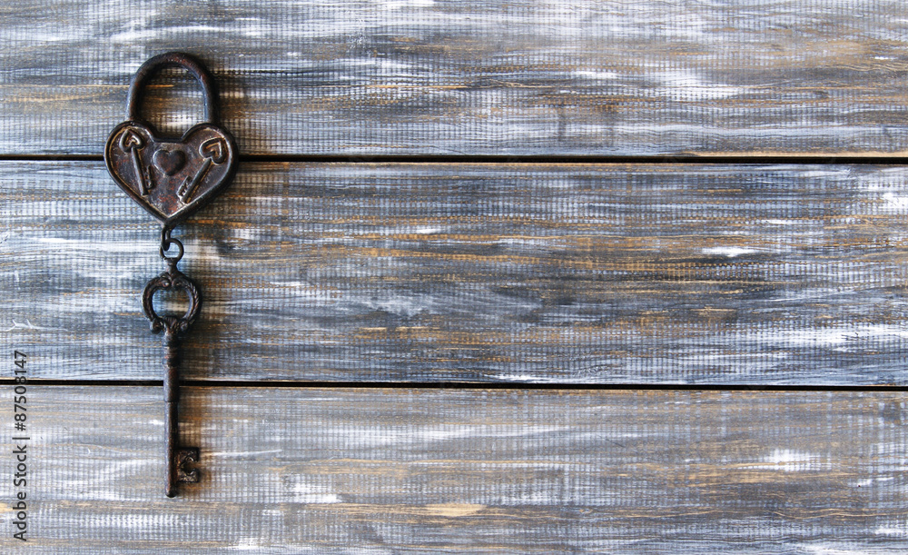 Heart and key on wooden background Heart and key on wooden background