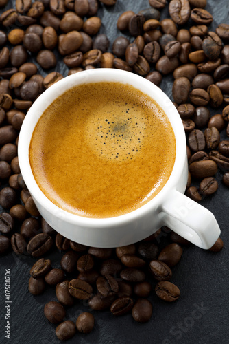 espresso on coffee beans background, top view
