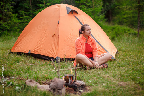 The woman at a fire with a tent