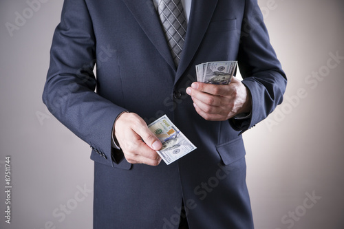 Businessman with money in studio. Corruption concept