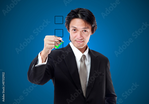 Young businessman checking mark on checklist.accept green icon.