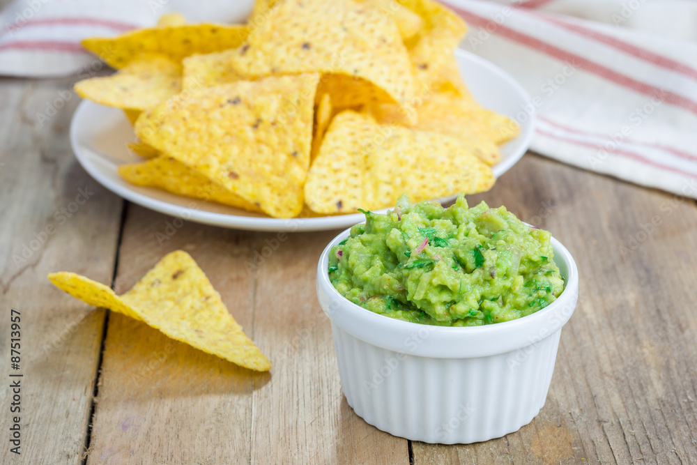 Cup with chunky guacamole served with nachos Cup with chunky guacamole served with nachos