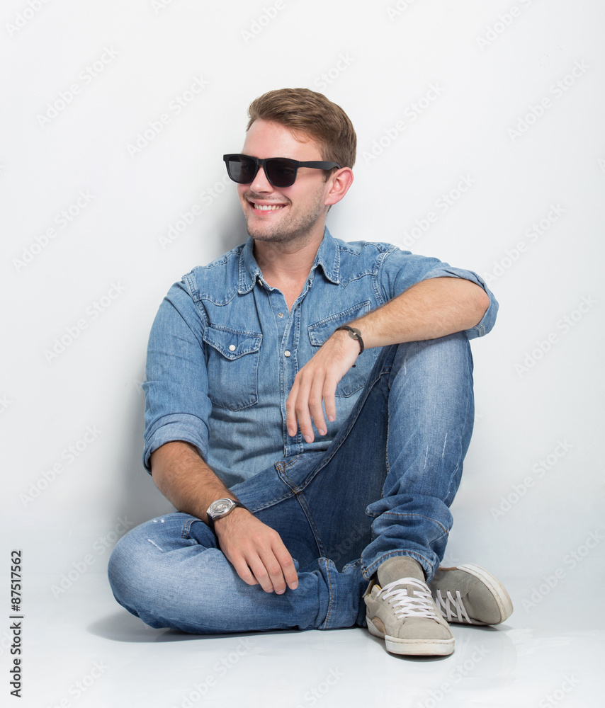 young male looking up and sitting on the floor young male looking up and sitting on the floor