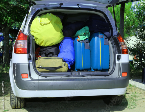 suitcases and luggage in the trunk while traveling in family