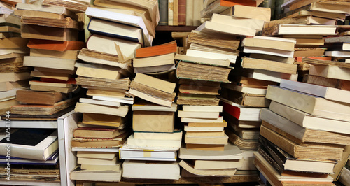 many books piled up for sale in the great library