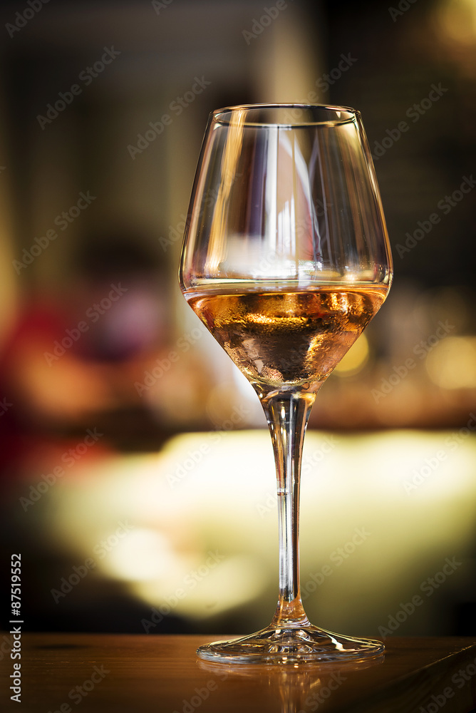 glass of rose wine on bar counter