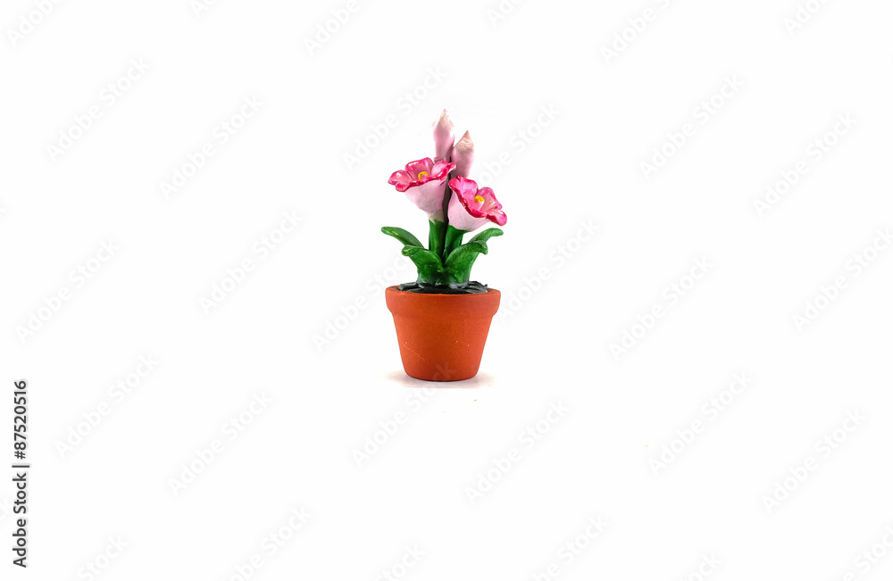 Plastic fake pink flower with brown pot toy isolated on white background Plastic fake pink flower with brown pot toy isolated on white background