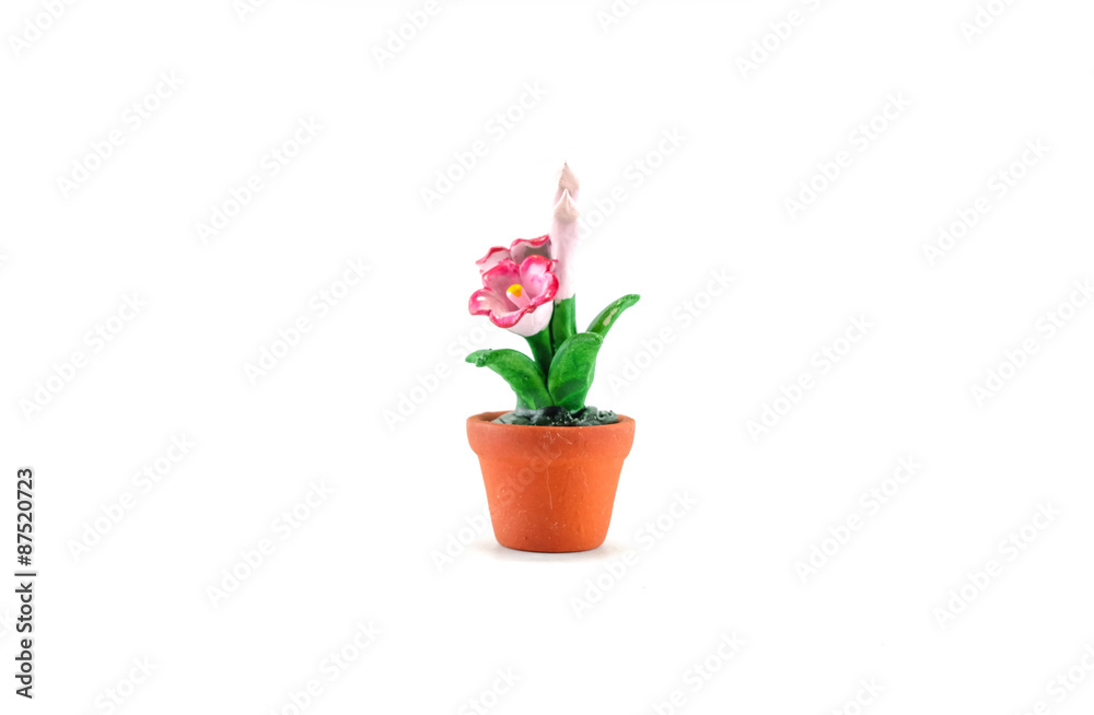 Plastic fake pink flower with brown pot toy isolated on white background