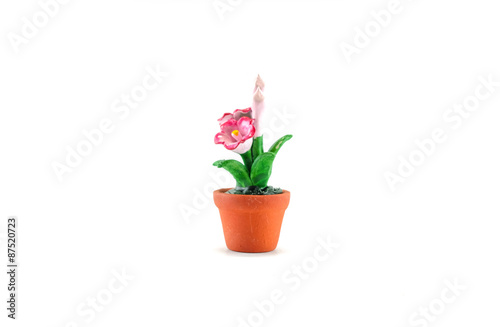 Plastic fake pink flower with brown pot toy isolated on white background