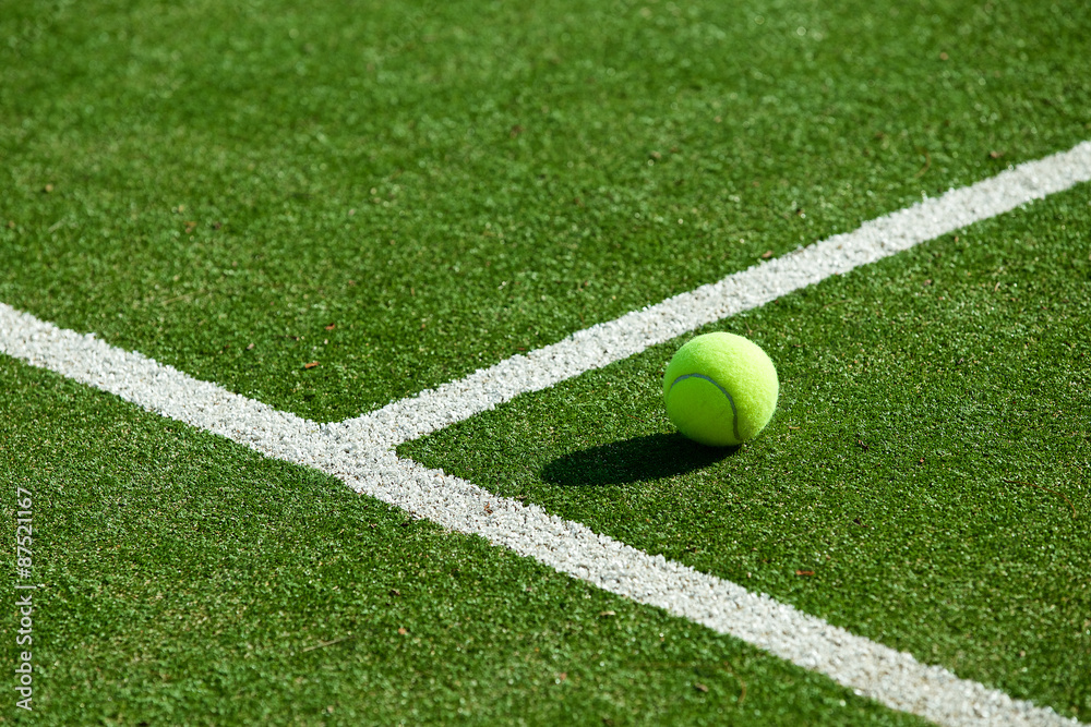 tennis ball on tennis grass court