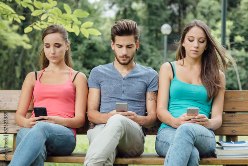 Teens at the park using smart phones