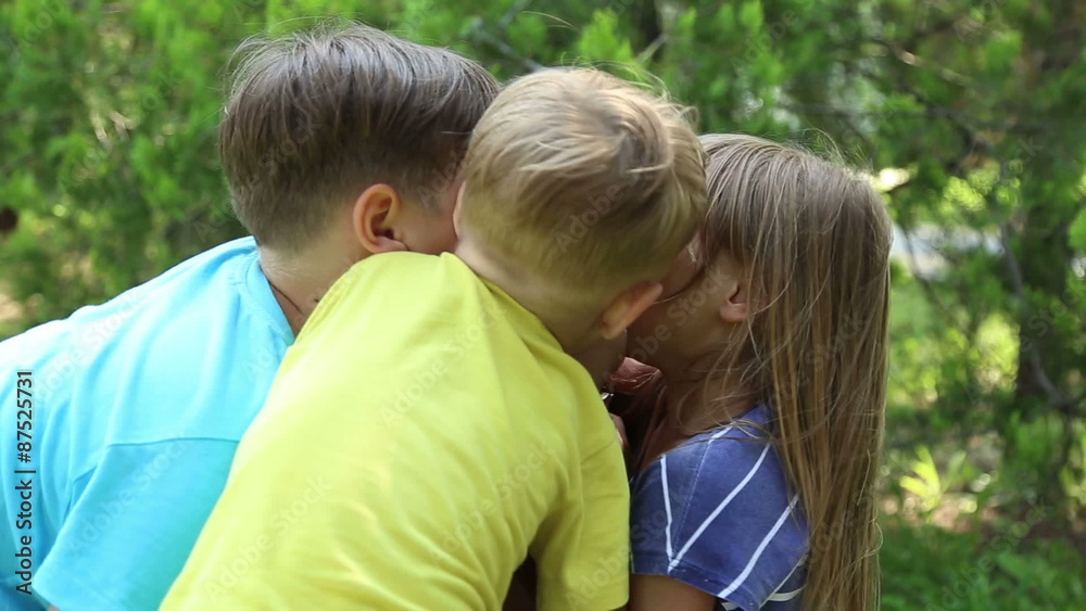 Mother with three children, two boys and girl, children hug and kiss her
Mother with three children, two boys and girl, children hug and kiss her