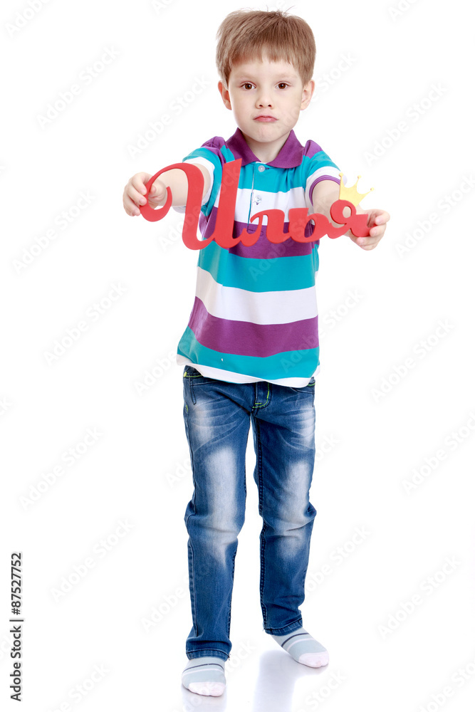 The boy holds in his hands the letters The boy holds in his hands the letters