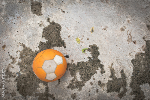 Old football on the  concrete floor