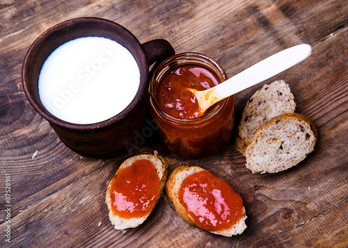 Toast with apricot jam on a wooden background