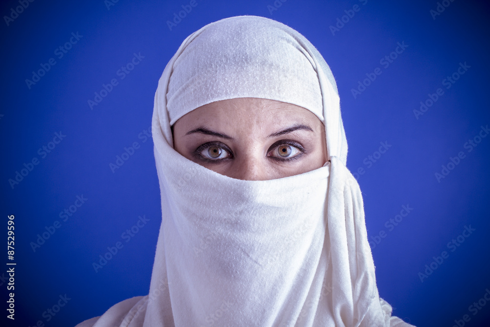 Beautiful arabic woman with traditional veil on her face, intens Beautiful arabic woman with traditional veil on her face, intens