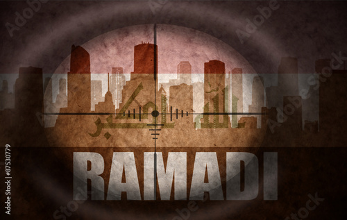 sniper scope aimed at the abstract silhouette of the city with text Ramadi at the vintage iraqi flag. concept photo