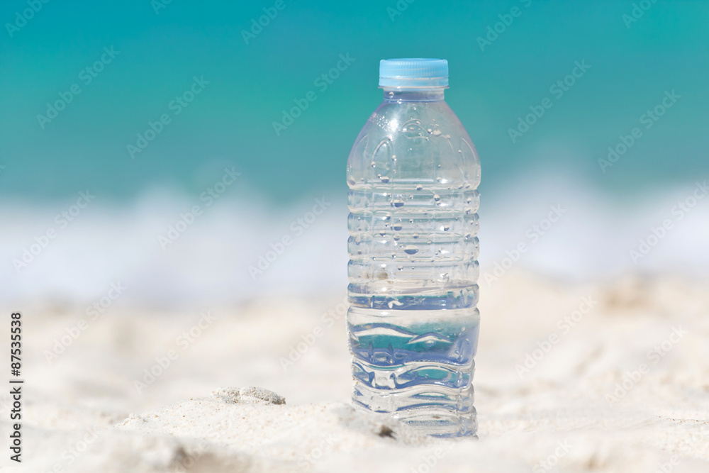 Water in bottle on sand Water in bottle on sand