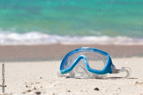 Swimming mask on white sand