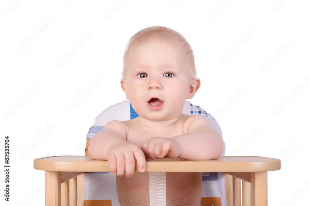 Adorable baby in high chair isolated Adorable baby in high chair isolated