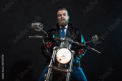 Stylish businessman waiting on his motorbike