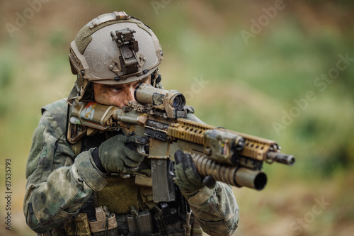 Portrait of a ranger in the battlefield with a gun