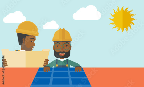 African man putting a solar panel on the roof.