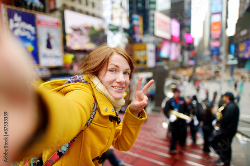 Beautiful woman taking a selfie on Times Square © MNStudio