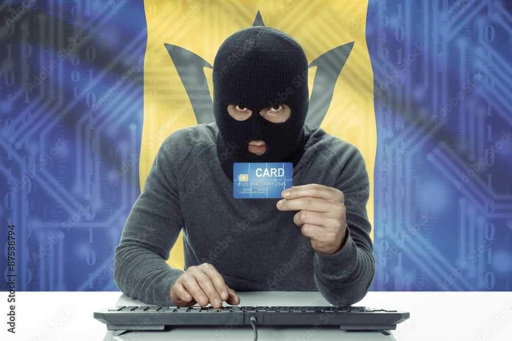 Dark-skinned hacker with flag on background holding credit card - Barbados