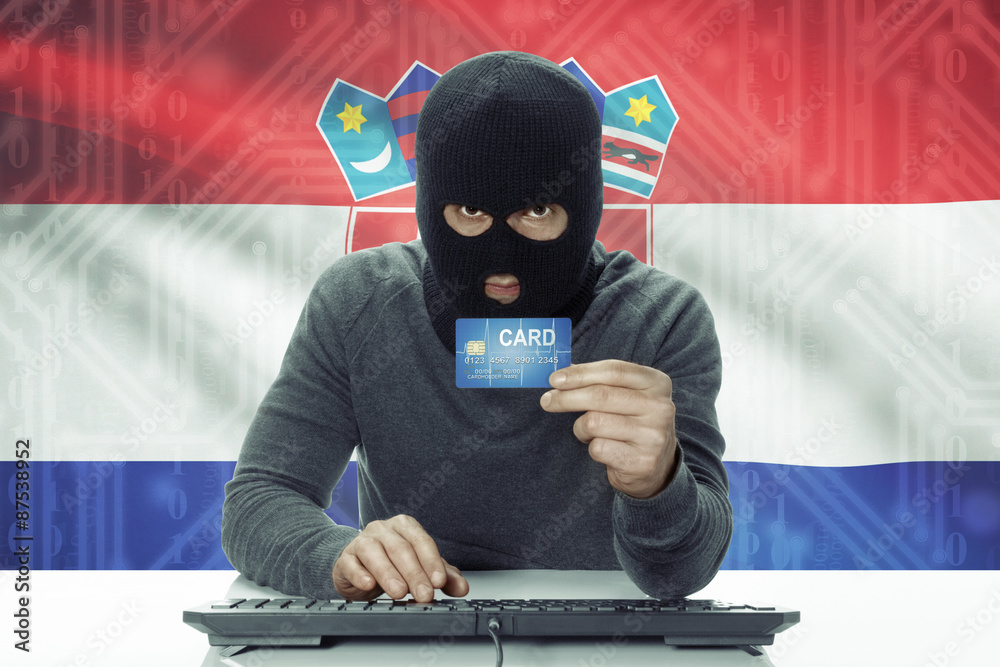 Dark-skinned hacker with flag on background holding credit card - Croatia Dark-skinned hacker with flag on background holding credit card - Croatia