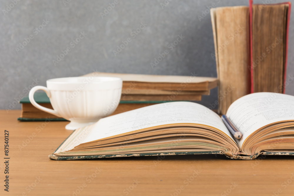 Fototapeta premium old book with pencil and coffee