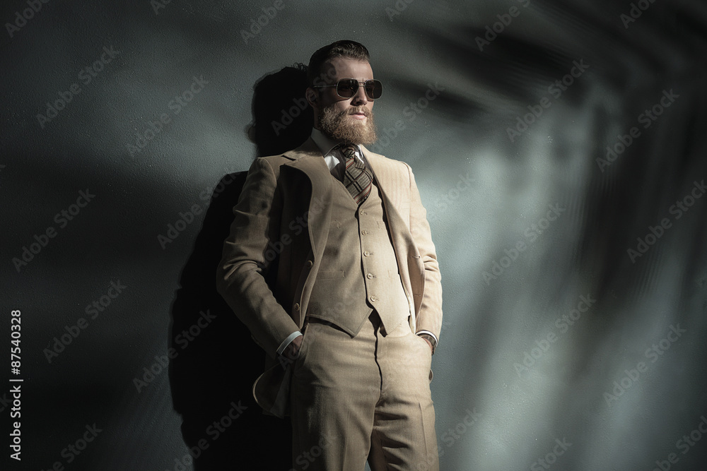 Elegant bearded man in a cream colored suit Elegant bearded man in a cream colored suit