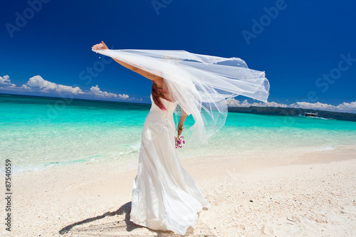 Happy dancing bride on beach