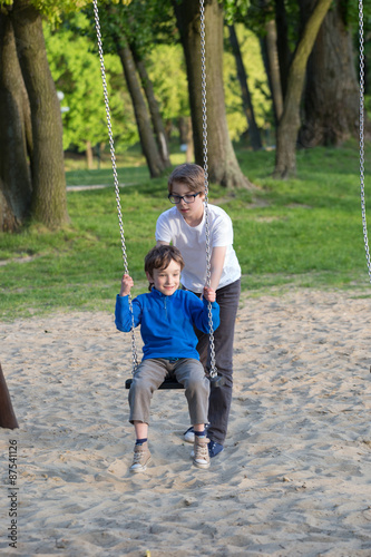 Fun on the swing, the boys together on the playground  © wip-studio
