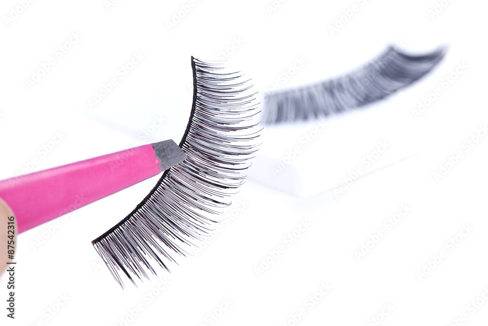 False lashes and pink pincers, closeup False lashes and pink pincers, closeup