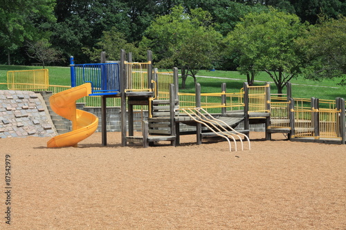 Vintage playground with yellow slide and pea gravel