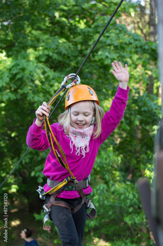 teenager climbing a rope park, Girl climbing in adventure park 