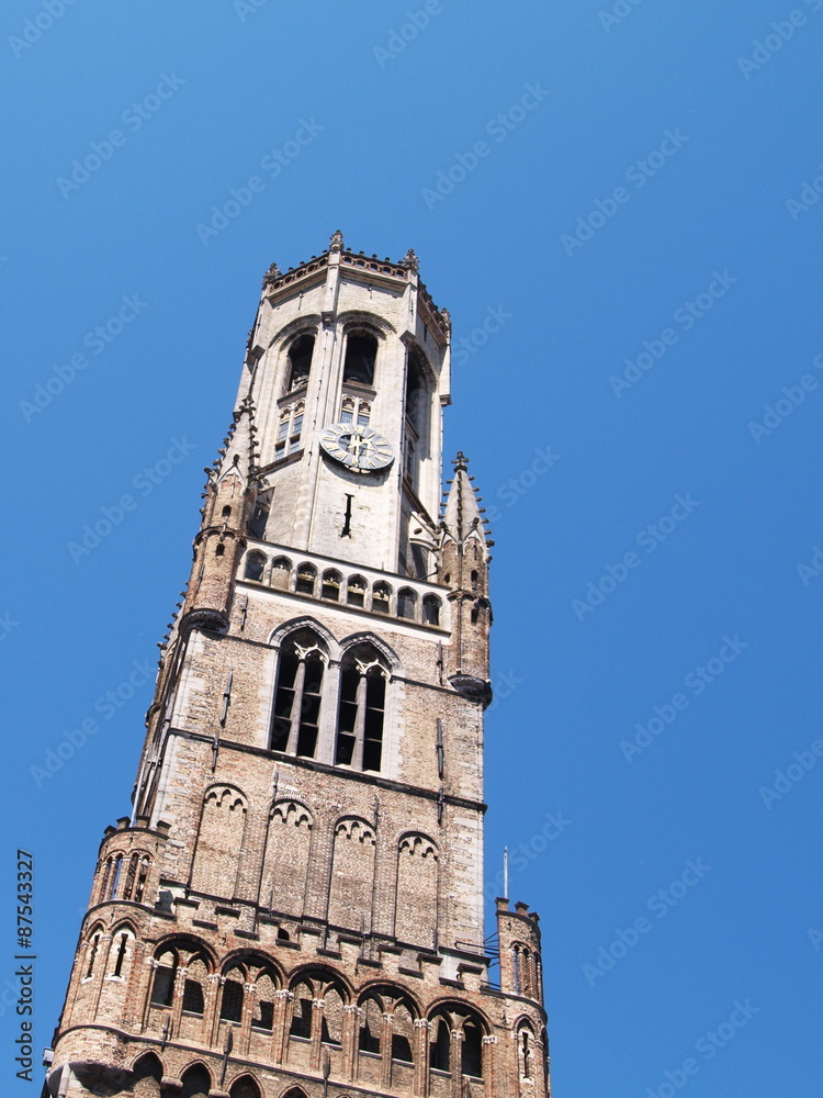 Tower Belfort in Brugge against blue sky