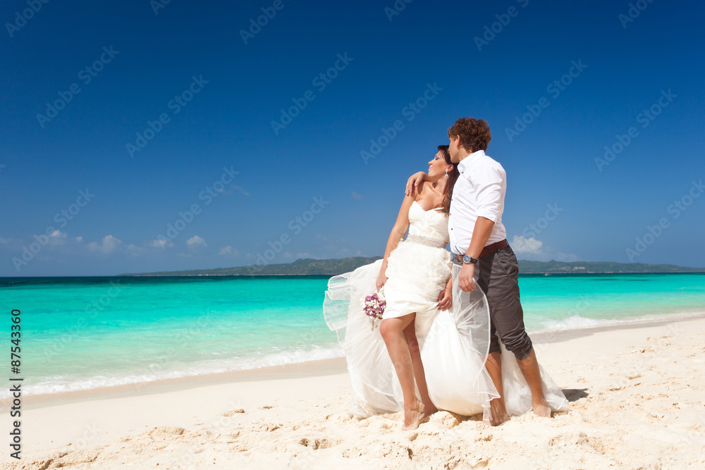 Bride and groom  having fun on beach