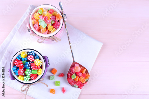 Sweet candies on wooden table, top view