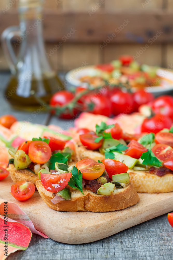 Bruschetta with zucchini, bacon, green onions and cherry tomatoe