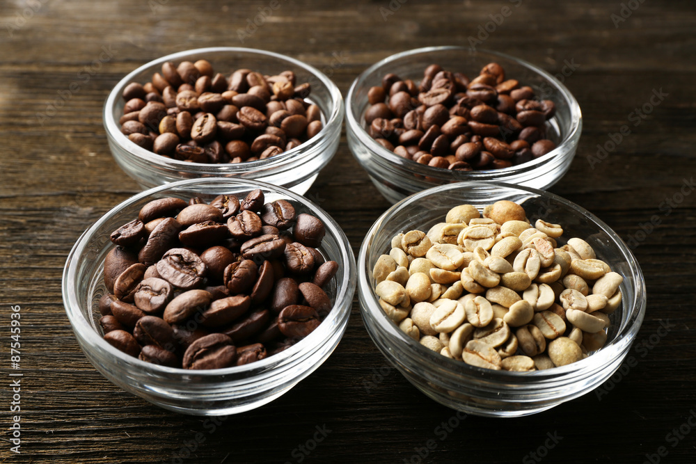 Coffee beans in saucers on wooden background Coffee beans in saucers on wooden background
