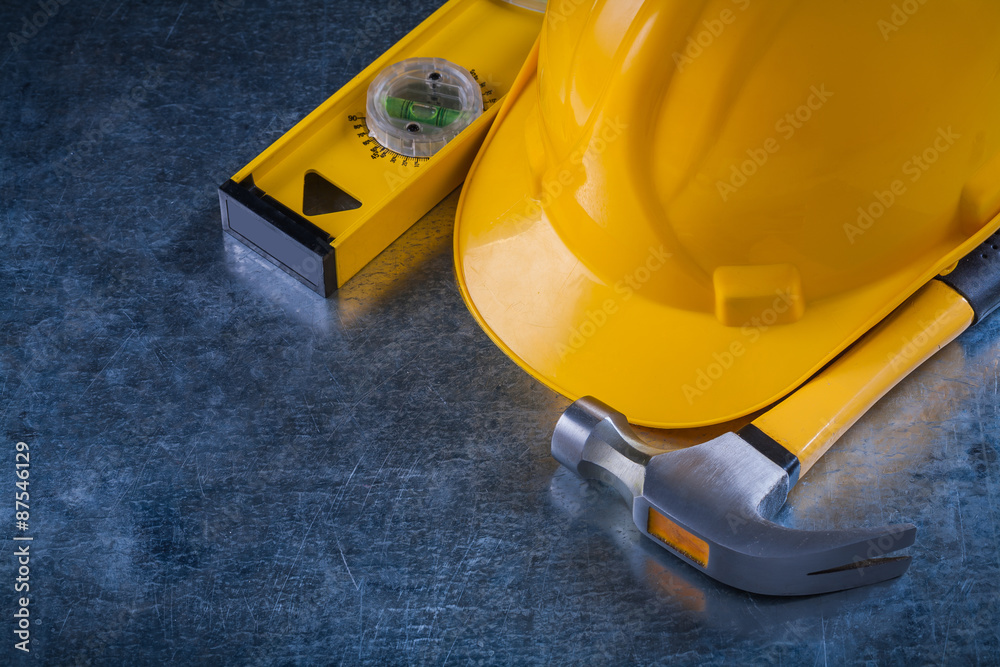 Fototapeta premium Claw hammer construction level and protective hard hat on scratc
