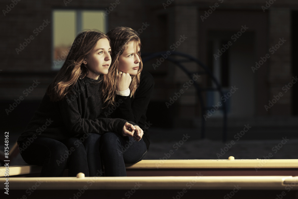 Fototapeta premium Two happy teen girls on the playground