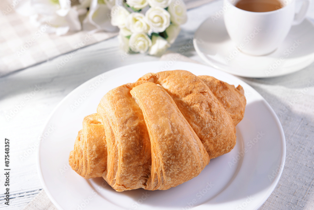 Delicious croissants on plate on table close-up Delicious croissants on plate on table close-up