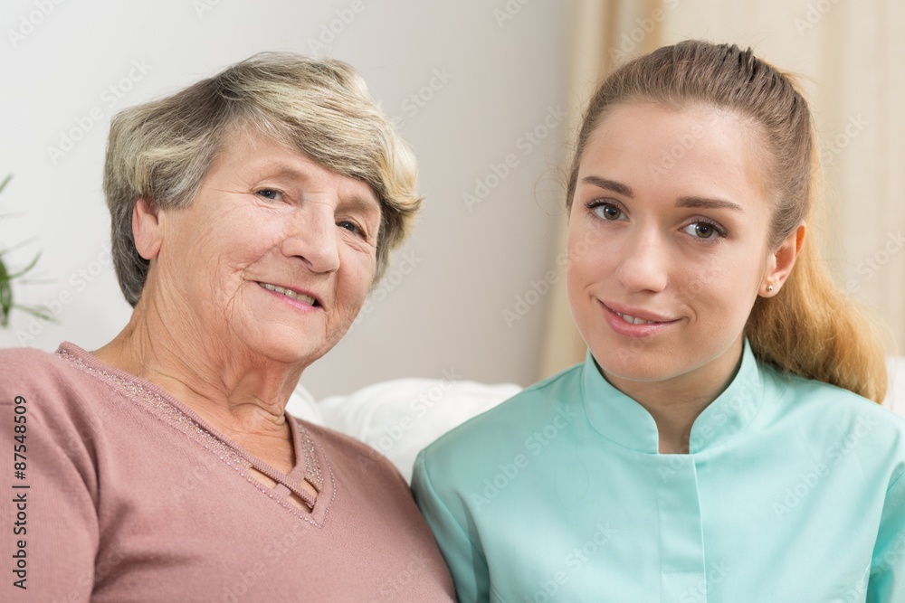 Smiling elderly woman and caregiver Smiling elderly woman and caregiver