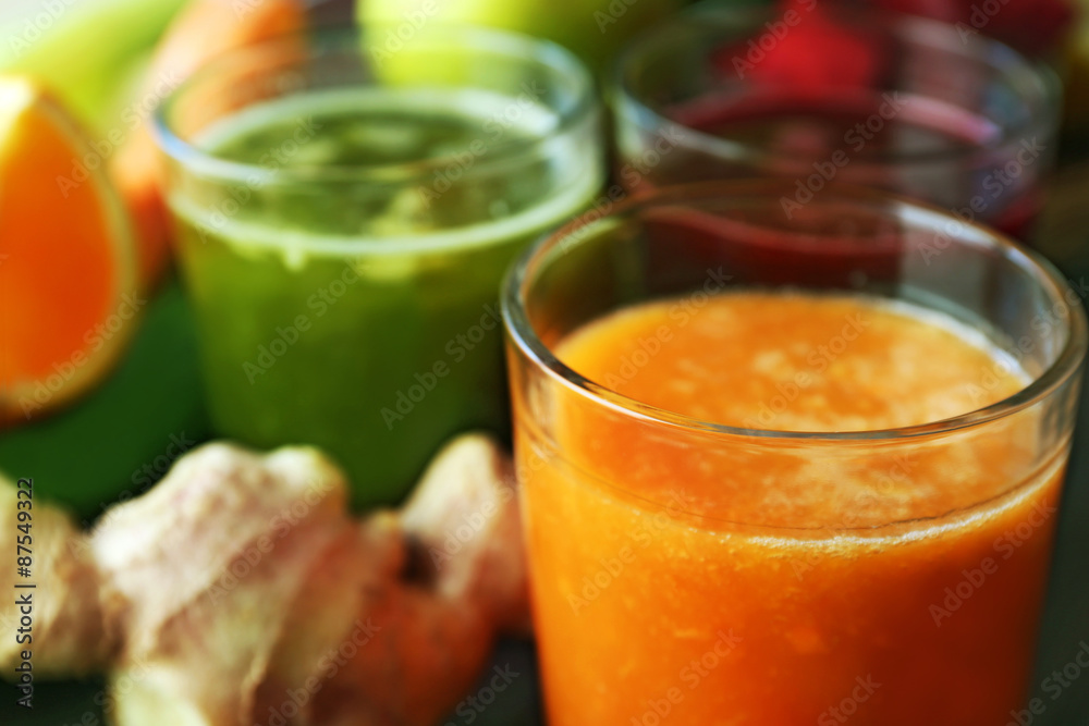 Assortment of healthy fresh juices on wooden table background Assortment of healthy fresh juices on wooden table background