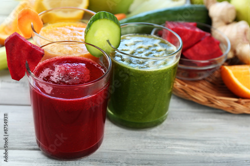 Assortment of healthy fresh juices on wooden table background